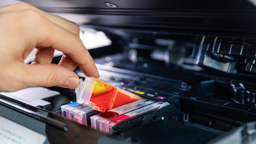 Person installing a new ink cartridge 