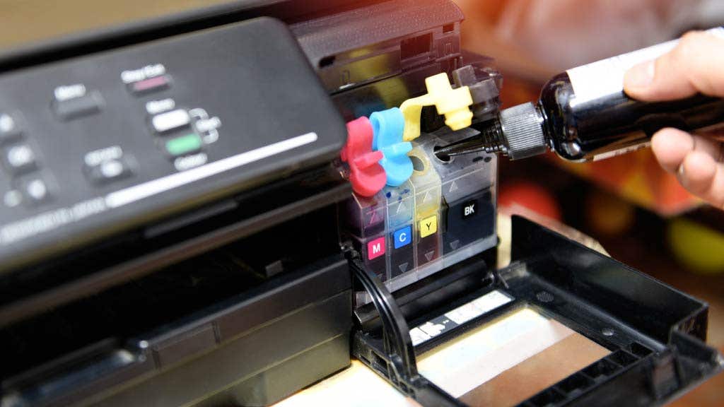 Person refilling ink cartridges in a printer