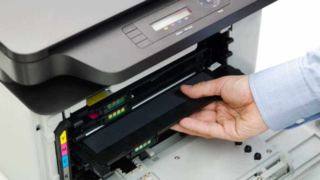 Photo of a person using a laser printer